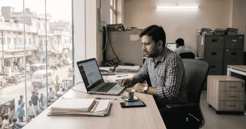 Indian small business owner checking his WordPress website security on a laptop